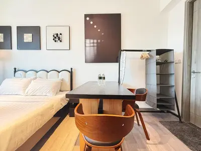 a bedroom with a bed and a table and chairs at Cozy Unit l Agile BB l 5min walk to TRX Pavilion in Kuala Lumpur