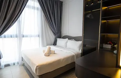a hotel room with a bed with a towel on it at Homey 2BR l Neu Suites l 5min to KL City in Kuala Lumpur