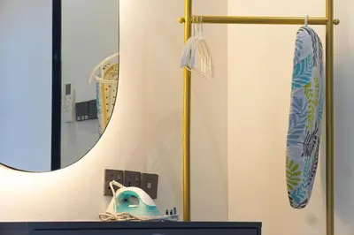 a bathroom with a mirror and a surfboard on a counter at Homey 2BR l Neu Suites l 5min to KL City in Kuala Lumpur