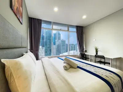a bedroom with a large bed with a large window at Vortex Suites Klcc by BEST TO BEST in Kuala Lumpur