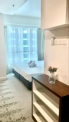 a bedroom with a bed and a large window at RaarFAM Homestay in Kuala Lumpur