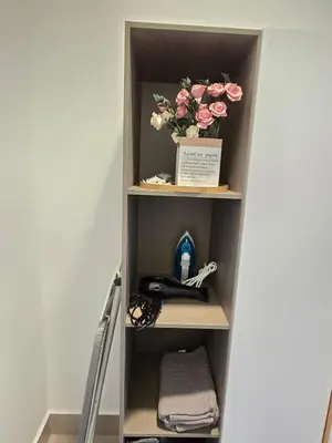 a book shelf with a vase of flowers on it at Razak City Kuala Lumpur D4 09 in Kuala Lumpur
