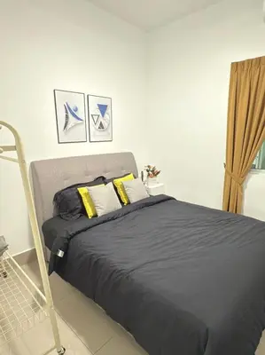 a bedroom with a bed with black sheets and yellow pillows at Razak City Kuala Lumpur D4 09 in Kuala Lumpur