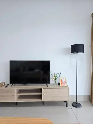 a flat screen tv on a wooden entertainment center in a living room at Razak City Kuala Lumpur D4 09 in Kuala Lumpur