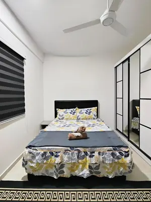 a bedroom with a bed with a teddy bear on it at Inap KL in Kuala Lumpur