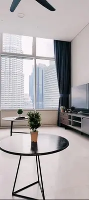 a living room with a table and a large window at Sky Suites Klcc By KD STAR Luxury Suites in Kuala Lumpur