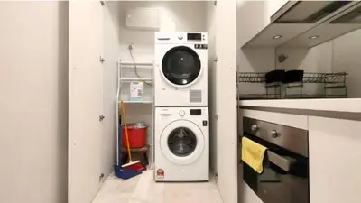 a washing machine and a washer in a kitchen at Sky Suites Klcc By KD STAR Luxury Suites in Kuala Lumpur