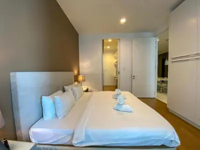 a large white bed with a teddy bear on it at Platinum Suites by Kuala Lumpur Malaysia in Kuala Lumpur