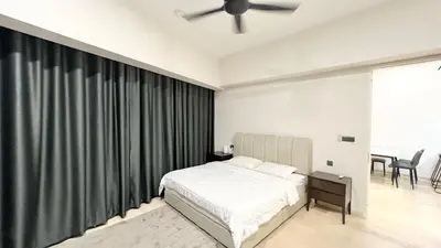 a bedroom with a bed and a ceiling fan at One Star KLCC in Kuala Lumpur