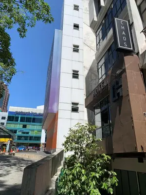 a building with a clock on the side of it at Chaos Boutique Hotel Kuala Lumpur in Kuala Lumpur