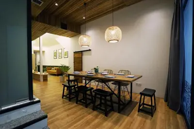 a dining room with a wooden table and chairs at Chaos Boutique Hotel Kuala Lumpur in Kuala Lumpur