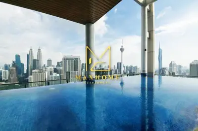 a swimming pool on the roof of a building with a city skyline at Maxhome Retreat at The Luxe in Kuala Lumpur
