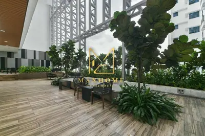 a lobby with chairs and a sign in a building at Maxhome Elite at The Luxe in Kuala Lumpur
