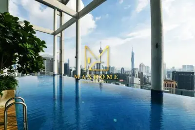 a swimming pool on the roof of a building with a city at Maxhome Elite at The Luxe in Kuala Lumpur