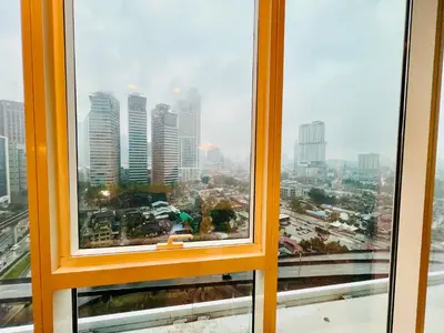 an orange window with a view of a city at Platinum Suites KLCC By Premium Hospitality in Kuala Lumpur