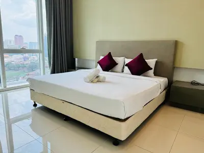 a bedroom with a bed with two teddy bears on it at Platinum Suites KLCC By Premium Hospitality in Kuala Lumpur