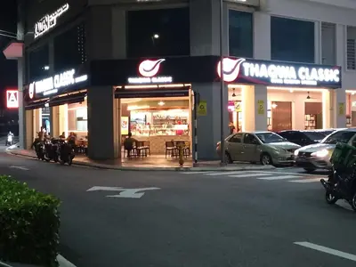 a restaurant on the side of a street at night at Anaqi Homestay by Razak City Sg Besi in Kuala Lumpur