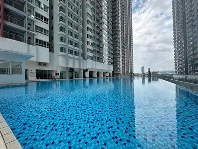 a large swimming pool in the middle of two tall buildings at Anaqi Homestay by Razak City Sg Besi in Kuala Lumpur
