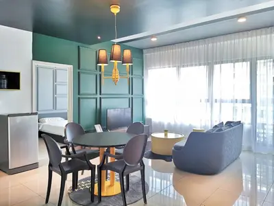 a living room with a dining room table and chairs at Arte Plus Ampang 2BR Private Lift Suite - Living Signature in Kuala Lumpur