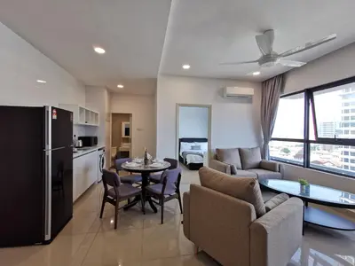 a kitchen and living room with a couch and a table at Arte Plus Ampang 2BR Private Lift Suite - Living Signature in Kuala Lumpur