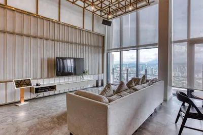 a living room with a couch and a television at Agile Residence Bukit Bintang, TRX by Isabella in Kuala Lumpur