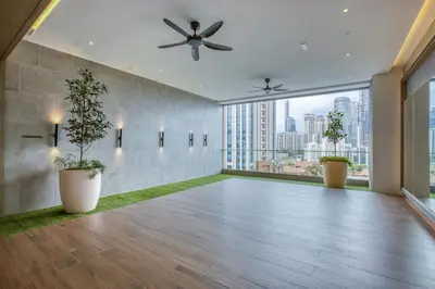a large room with a ceiling fan and large windows at Agile Residence Bukit Bintang, TRX by Isabella in Kuala Lumpur