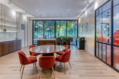 a dining room with a table and red chairs at Agile Residence Bukit Bintang, TRX by Isabella in Kuala Lumpur