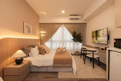 a bedroom with a bed and a desk and a kitchen at Agile Residence Bukit Bintang, TRX by Isabella in Kuala Lumpur