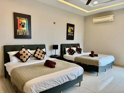 a room with two beds in a room at B3A l KLCC TRX Contemporaryl 17 Pax in Kuala Lumpur