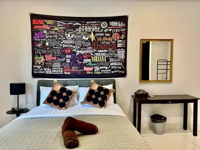 a bedroom with a bed with a wall covered in graffiti at B3A l KLCC TRX Contemporaryl 17 Pax in Kuala Lumpur