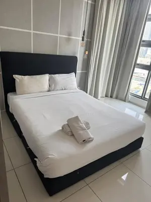 a bed with two towels on it in a room at Robertson suites At Bukit Bintang South Lobby in Kuala Lumpur
