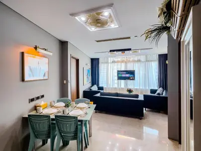 a living room with a table and a couch at Vortex Suites Klcc By VIP SUITES in Kuala Lumpur
