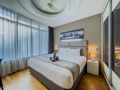 a bedroom with a large bed and large windows at Vortex Suites Klcc By VIP SUITES in Kuala Lumpur