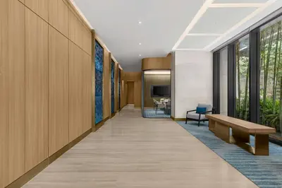 a hallway with a bench and a table at Marriott Executive Apartments Kuala Lumpur in Kuala Lumpur
