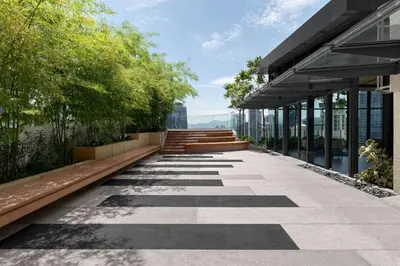 a walkway in front of a building with trees at Marriott Executive Apartments Kuala Lumpur in Kuala Lumpur