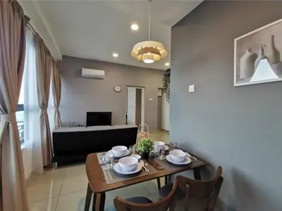 a dining room with a table and a couch at Arte Plus Ampang 2BR Family Suite - Living Signature in Kuala Lumpur