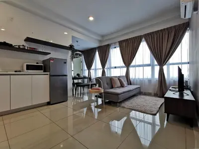 a kitchen and living room with a couch and a table at Arte Plus Ampang 2BR Family Suite - Living Signature in Kuala Lumpur