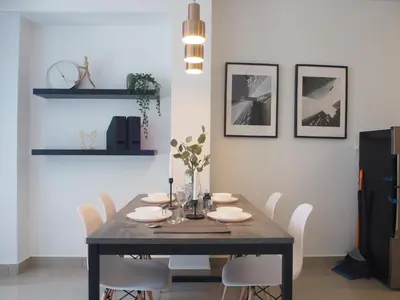 a dining room with a wooden table and white chairs at Arte Plus Ampang 2BR Family Suite - Living Signature in Kuala Lumpur