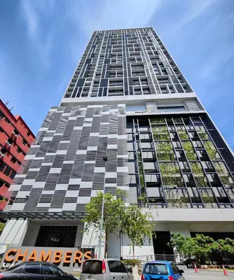 a tall building with cars parked in front of it at Lovely Studio room in KL in Kuala Lumpur