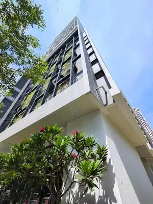 a tall building with trees in front of it at Lovely Studio room in KL in Kuala Lumpur