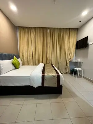 a bedroom with a large bed in front of a window at SS Grey Hotel BB in Kuala Lumpur