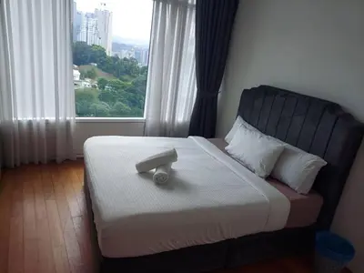 a bed in a room with a large window at Vortex Galaxy Suites KL in Kuala Lumpur