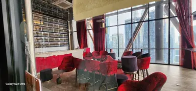 a room with a bunch of chairs and windows at Scarletz Suite By Skyscraper in Kuala Lumpur