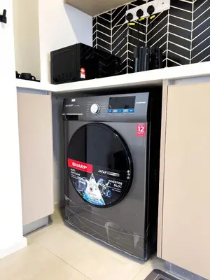 a dvd machine sitting under a counter at Premier Stay KL - Bangsar South - King Bed - Work Space - Near LRT, VE, Conexxion in Kuala Lumpur