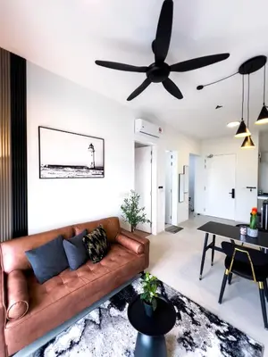 a living room with a couch and a ceiling fan at Premier Stay KL - Bangsar South - King Bed - Work Space - Near LRT, VE, Conexxion in Kuala Lumpur
