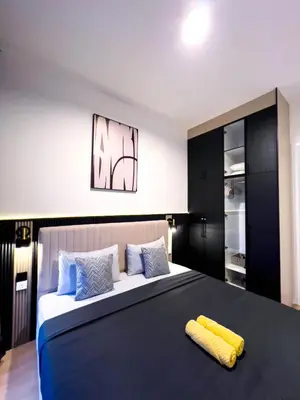 a bedroom with a large bed with a yellow towel on it at Premier Stay KL - Bangsar South - King Bed - Work Space - Near LRT, VE, Conexxion in Kuala Lumpur