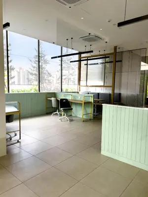 an office with desks and chairs and large windows at Premier Stay KL - Bangsar South - King Bed - Work Space - Near LRT, VE, Conexxion in Kuala Lumpur