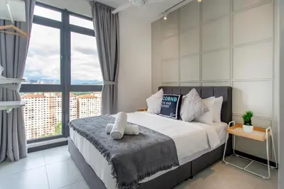 a bedroom with a bed and a large window at Neu Suites KL with Daily Breakfast Included in Kuala Lumpur