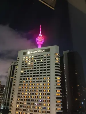 a tall building with a pink tower on top of it at Vortex klcc by Elham in Kuala Lumpur