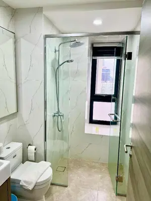 a bathroom with a glass shower and a toilet at Agile Bukit Bintang By Comfort Suites in Kuala Lumpur